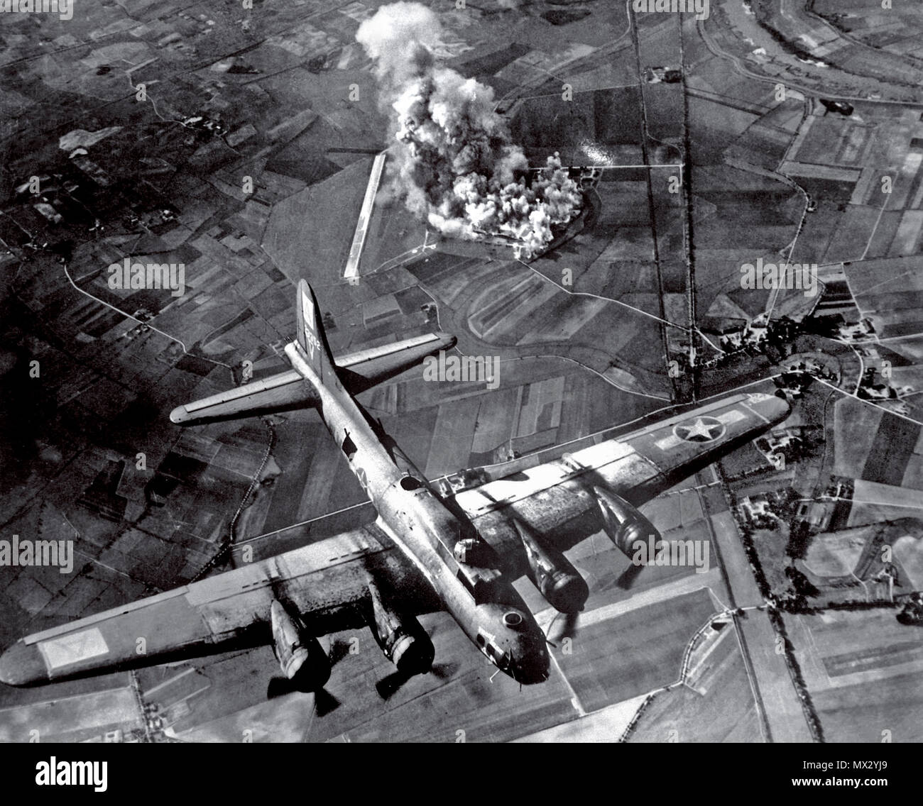 BOMBING B-17 Germany WW2  1940’s Bombing Raid by a B-17 Flying Fortress of the American 8th Air Force on a Focke Wulf aircraft manufacturing plant at Marienburg Germany 1943. This notable World War II aerial bombing raid was a total success obliterating the plant completely with pinpoint bombing Stock Photo