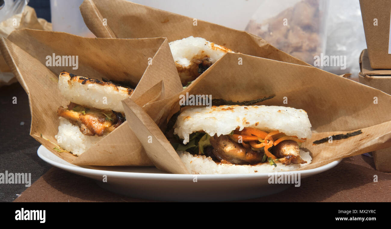 food samples, variations of diverse Asian burgers. The meat burgers served in the rice buns during the Asian street farmers market. Stock Photo