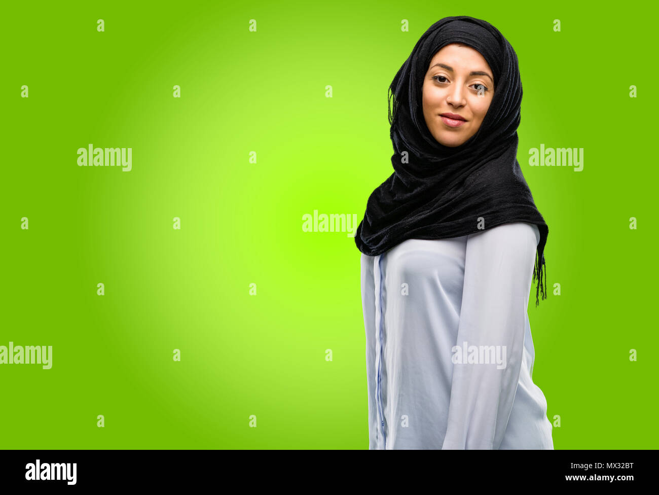 Young arab woman wearing hijab confident and happy with a big natural ...