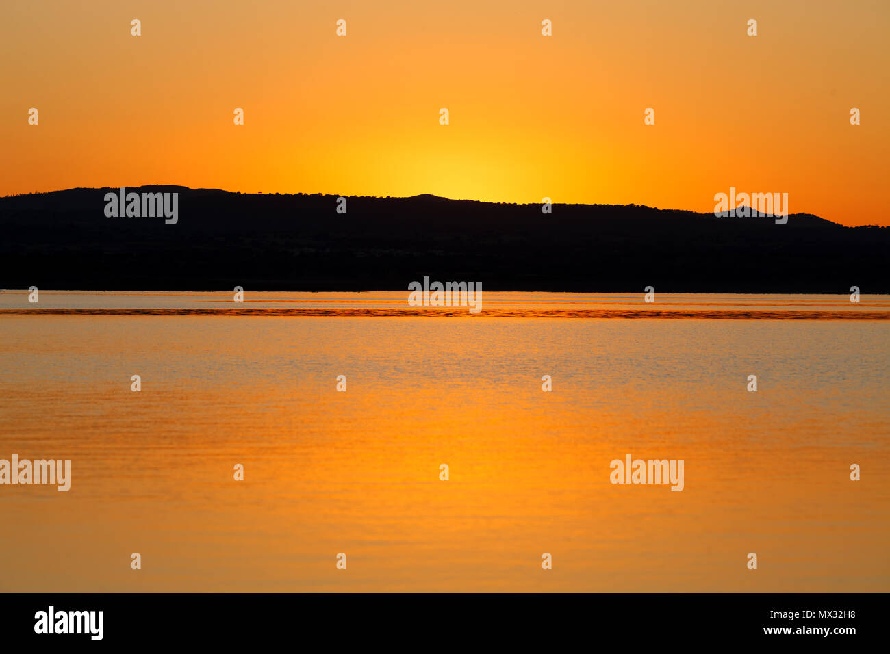 Amazing sunset with golden and black colours Stock Photo - Alamy