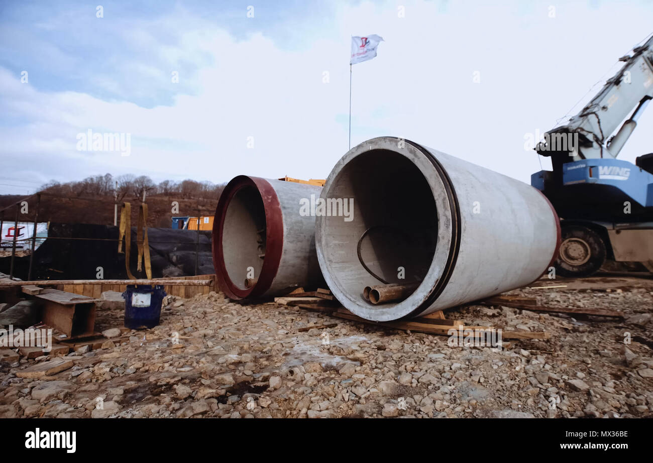 Concrete pipes. A platform with equipment for pipeline operations. Pipe  penetration Stock Photo - Alamy