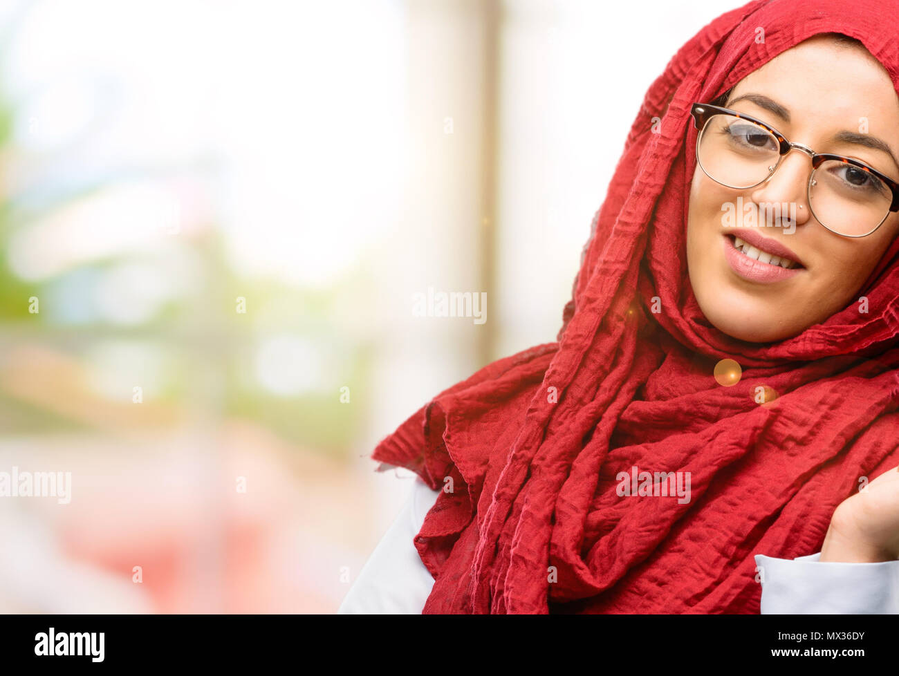 Young arab woman wearing hijab confident and happy with a big natural ...