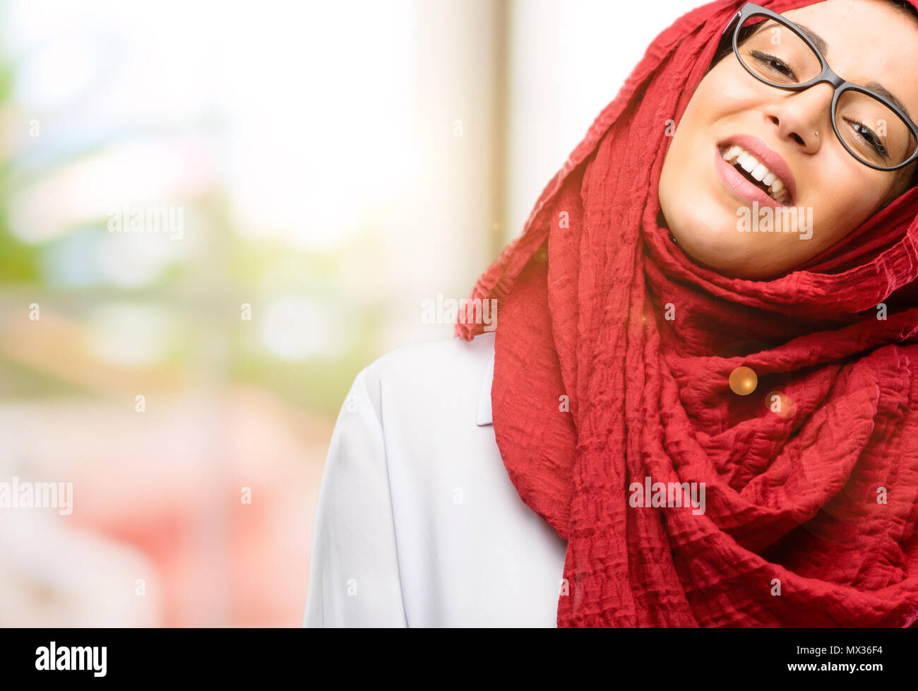 Young arab woman wearing hijab confident and happy with a big natural ...