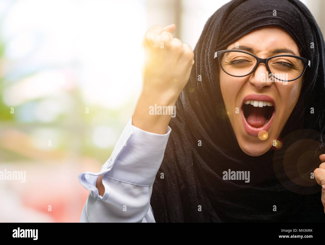 Young arab woman wearing hijab happy and excited celebrating victory ...