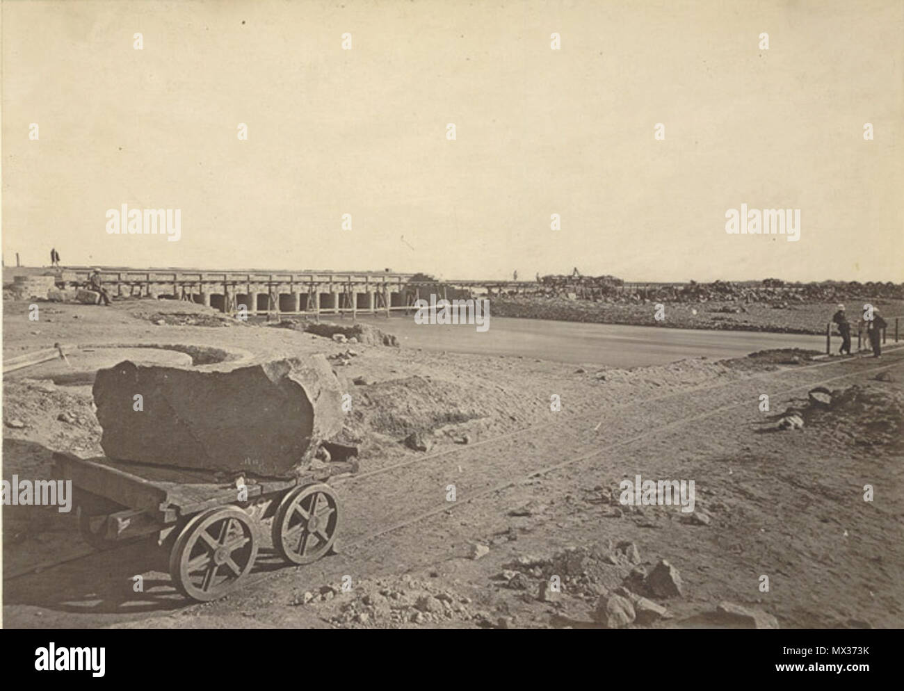 . English: Image of Agra Canal, Headworks. Unknown Photographer c. 1871-73. Photograph from Crofton Collection: 'Public works including the Manora Breakwater and the River Son canal system' taken by an unknown photographer, c.1871-73. The Agra canal, opened in 1874, was a major civil engineering project and the water was used for both transportation and irrigation. The canal drew its water from the River Jumna at Okhla, about 10km from Delhi, and from there it continued until finally joining the Banganga River about 20 km from Agra. Irrigation waters from the canal helped to lessen the impact  Stock Photo