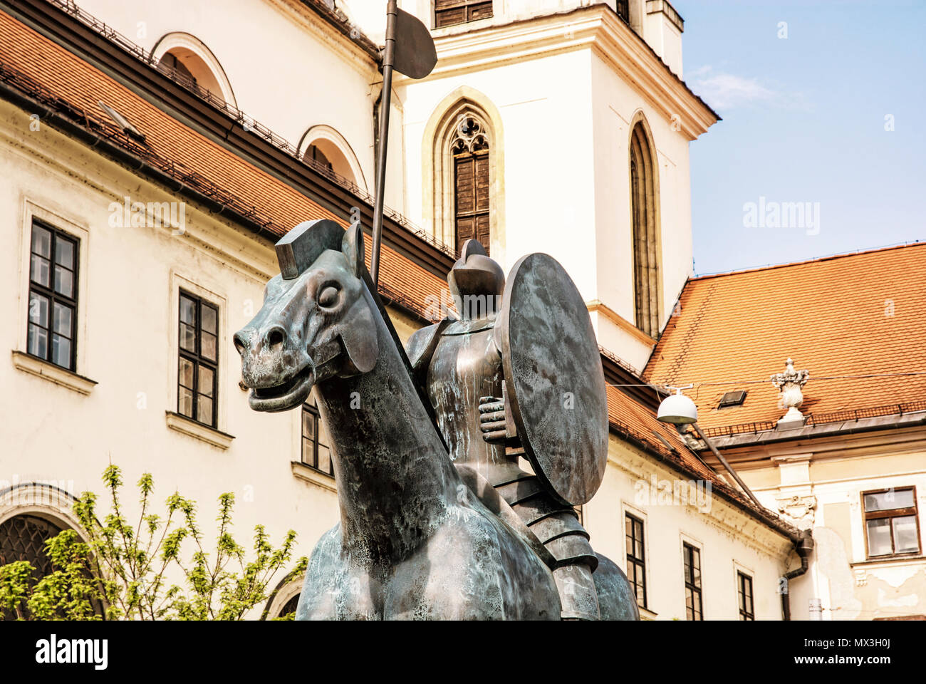 Equestrian statue of margrave Jobst of Luxembourg and Church of St. Thomas, Brno, Moravia, Czech republic. Yellow photo filter. Stock Photo