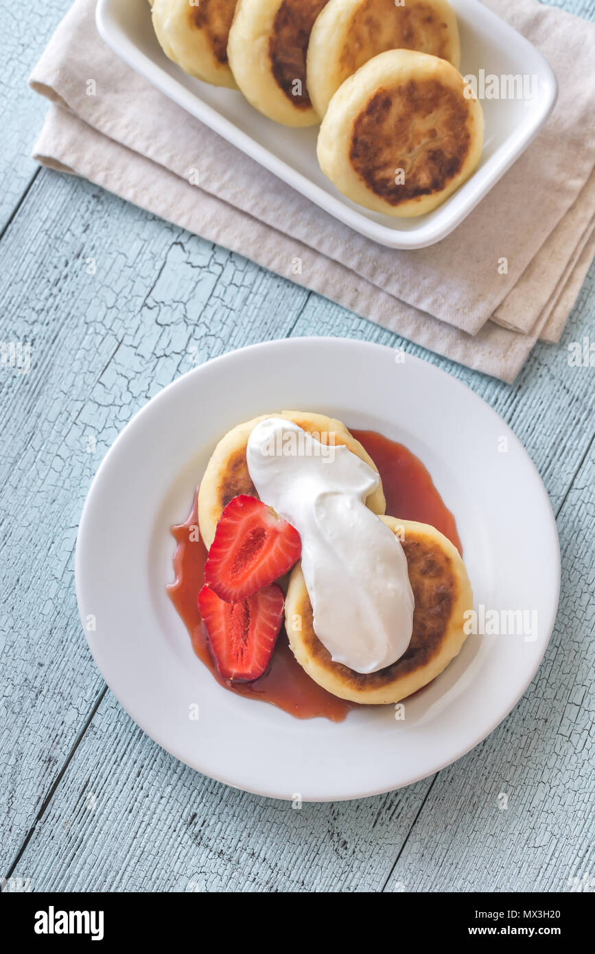 Cottage Cheese Patties With Whipped Cream And Berry Syrup Stock