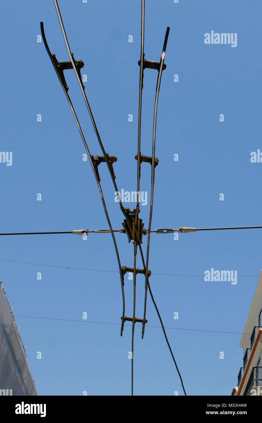 Tram electric wires on blue sky background. Power cables that supply