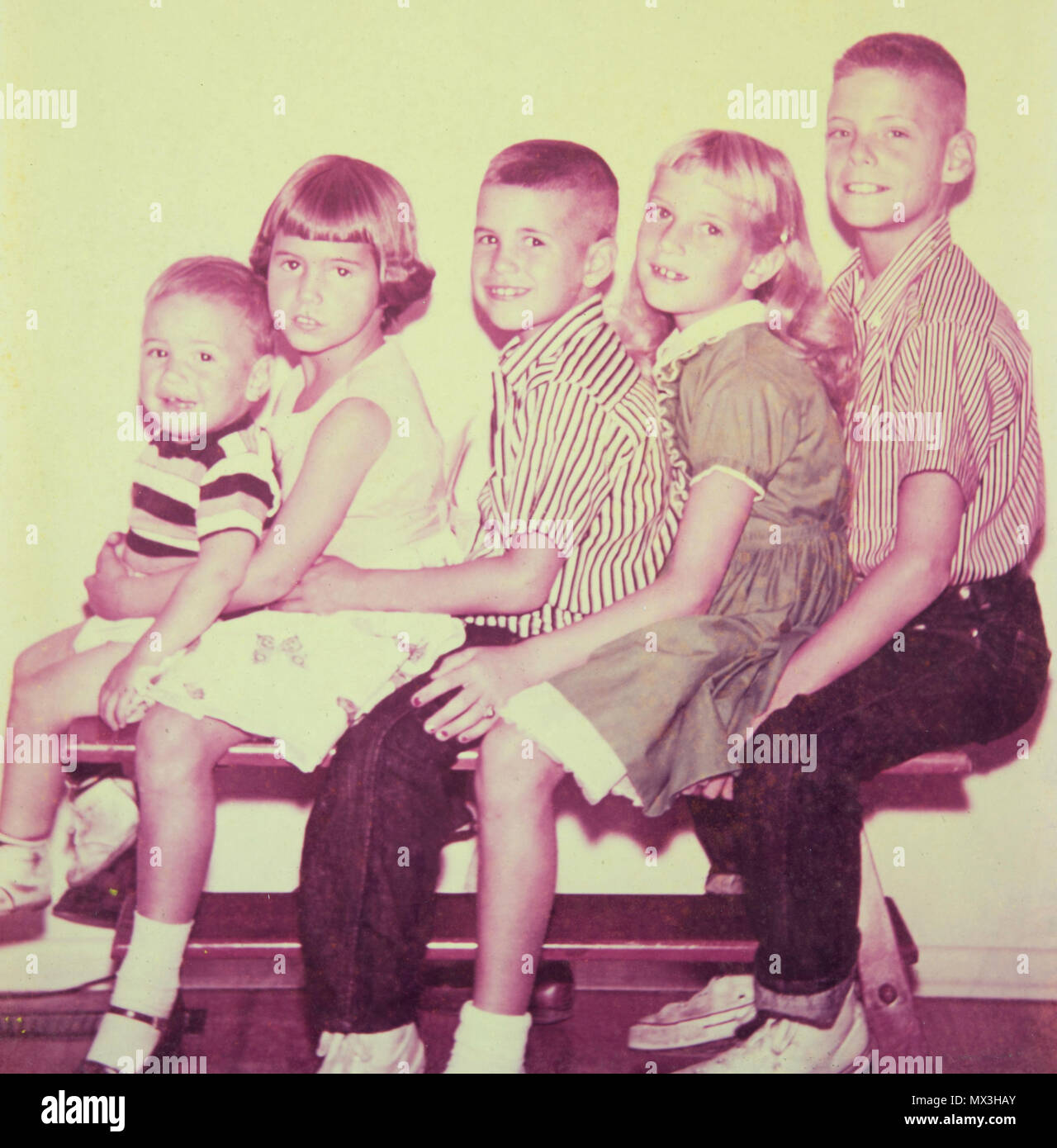 Stairstep Siblings Pose of Family Photo Sitting on a Coffee Table 1958, USA Stock Photo
