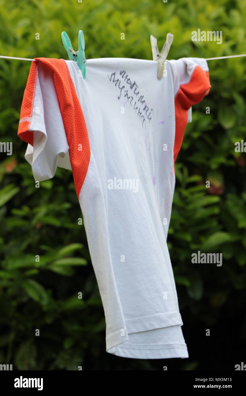 T-shurt with the inscription in Russian 'The man I love' on a washing line. Stock Photo
