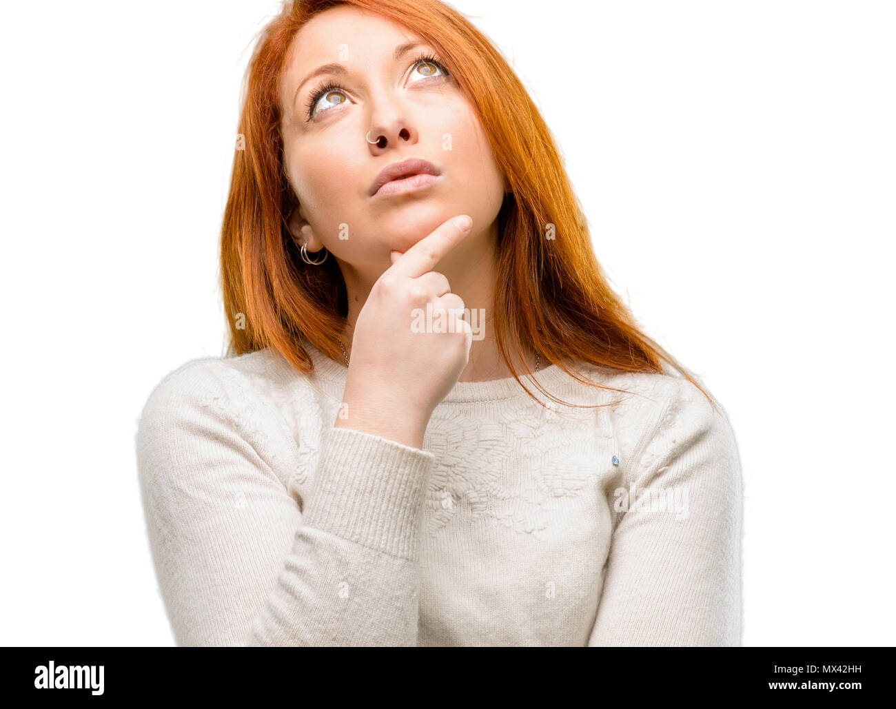 Beautiful young redhead woman thinking and looking up expressing doubt ...