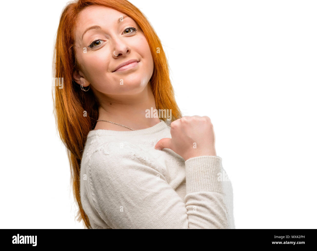 Beautiful young redhead woman proud, excited and arrogant, pointing with victory face isolated over white background Stock Photo