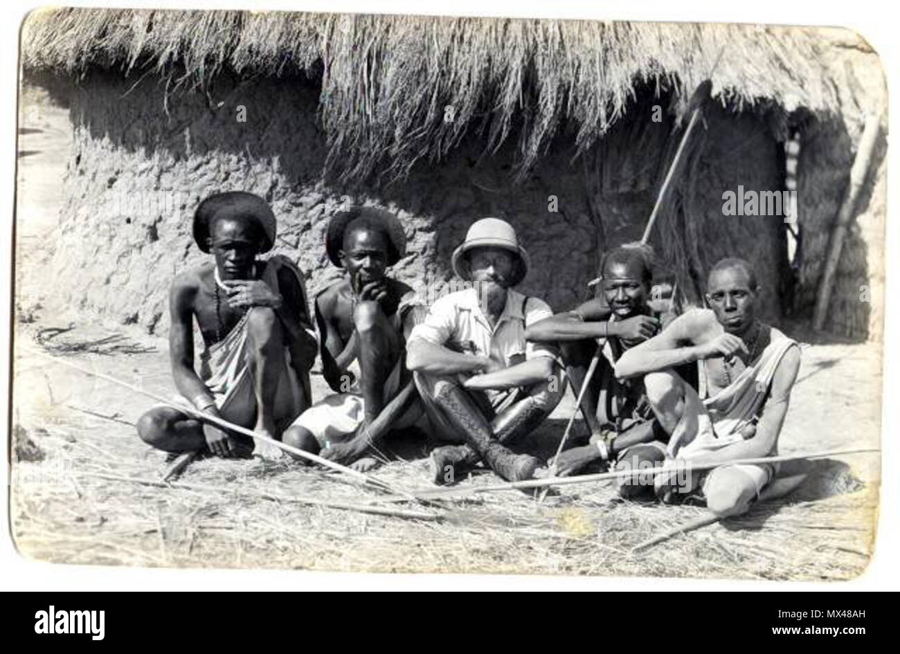 . Kazimierz Nowak among men from Shilluk tribe (near Malakal town, South Sudan, Africa). The photo probably taken by Kazimierz Nowak (1897-1937) during his trip through Africa - a Polish traveller, correspondent and photographer. Probably the first man in the world who crossed Africa alone from the North to the South and from the South to the North (from 1931 to 1936; on foot, by bicycle and canoe). . circa about 1931-36. probably Kazimierz Nowak or an unknown author 42 Among Shillukian people Stock Photo