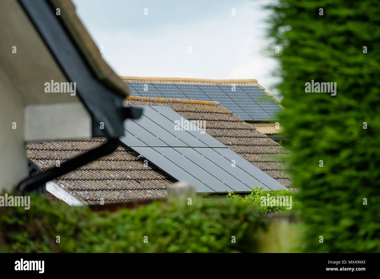 Isolated, shallow focus of newly installed Solar panels on a detached house. Also in view is