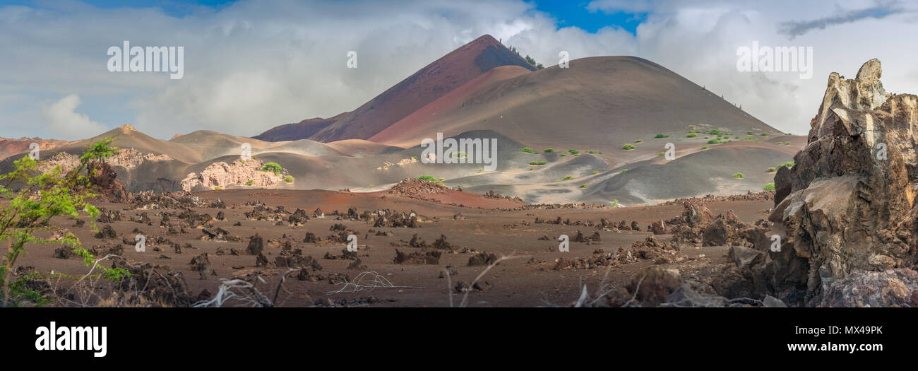 View over the lava fields towards the colourful hills made of volcanic sand called The Sisters on the Ascension Island, in the south Atlantic ocean. Stock Photo