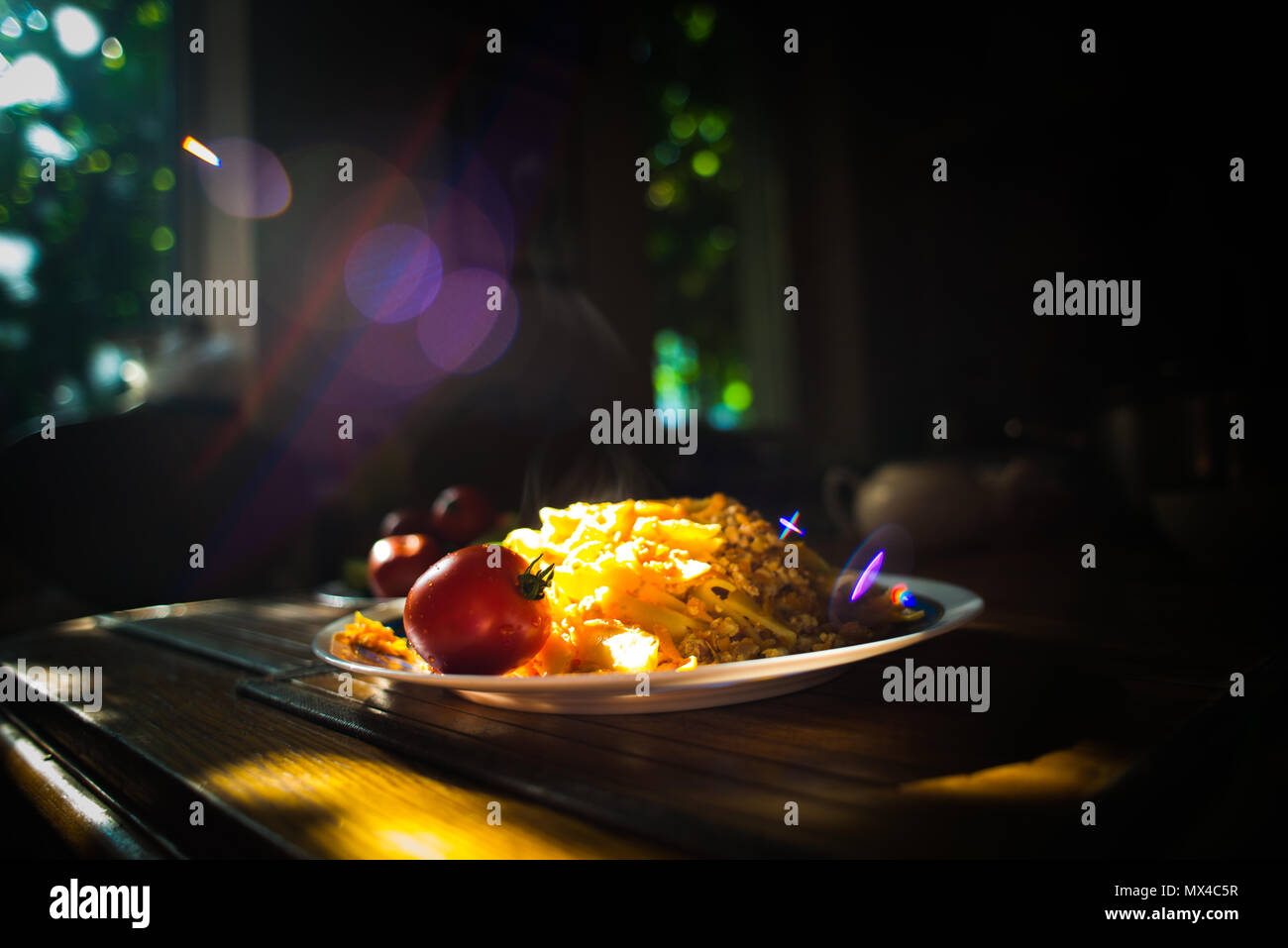 A plate with steamigh hot macaroni (pasta), and red tomato Stock Photo
