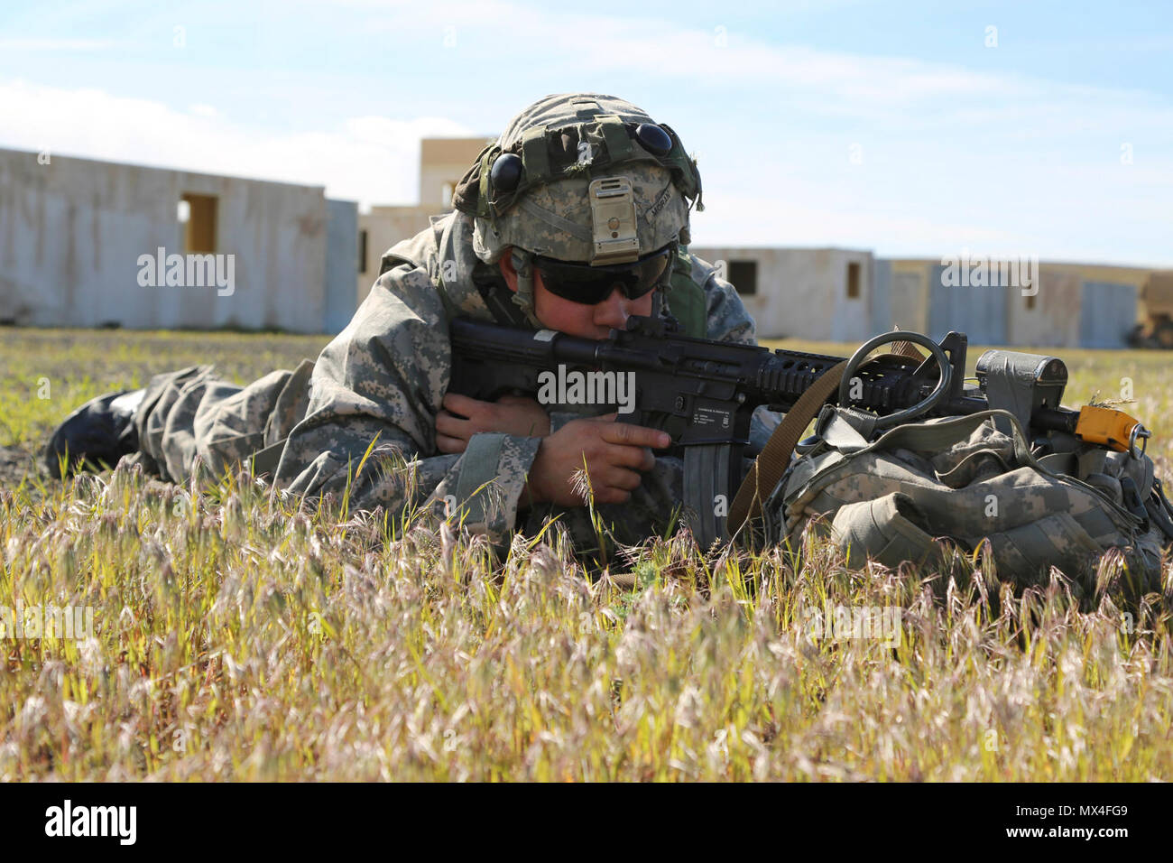 U.S. Army Sgt. Carlos Moran, 744th Ordnance Company (EOD), 184th Ordnance Disposal Battalion (EOD), 52nd Ordnance Group (EOD), pulls security outside a training village during a situational training exercise (STX) at the Yakima Training Center, Yakima, Wash., April 28, 2017. The final days of the CBRNE Leaders Course are comprised of STX lanes that test what the Soldiers' learned throughout the duration of the course. Stock Photo
