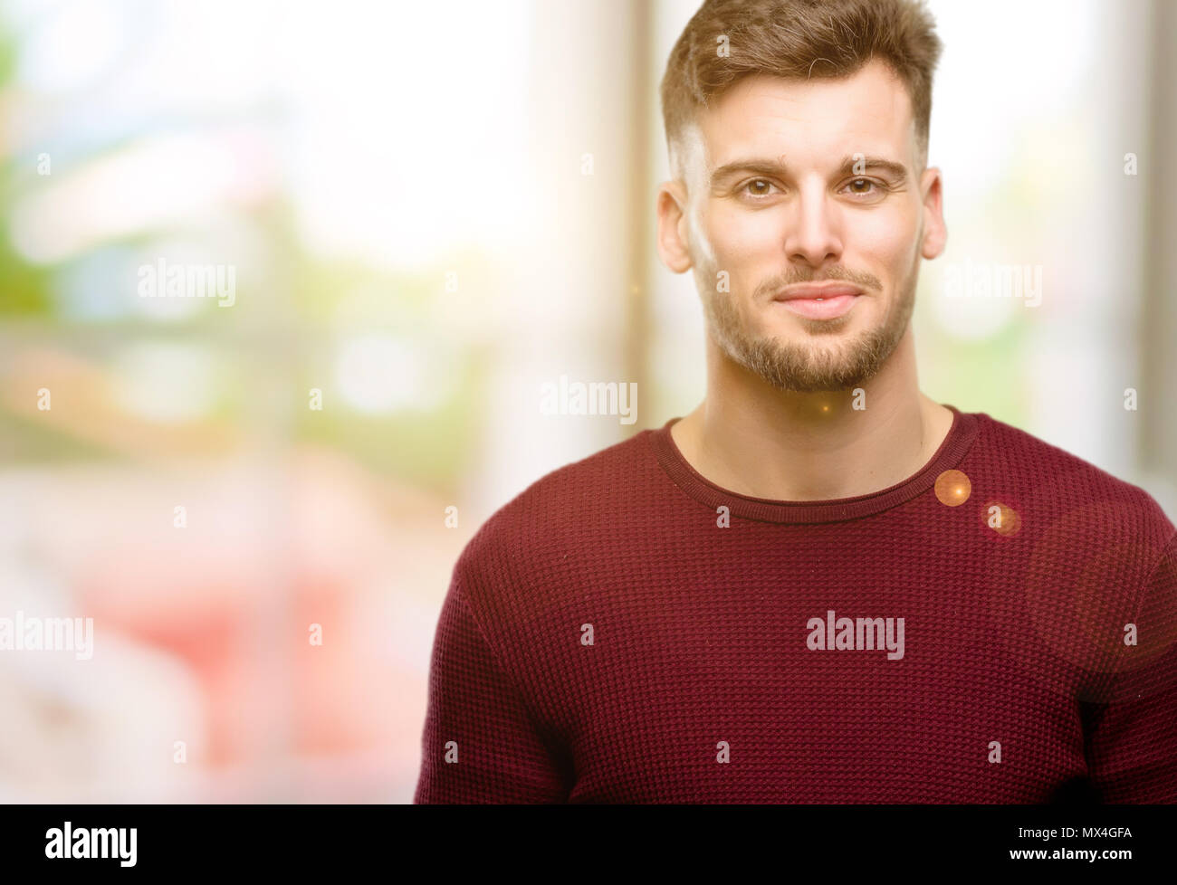 Handsome young man confident and happy with a big natural smile looking ...