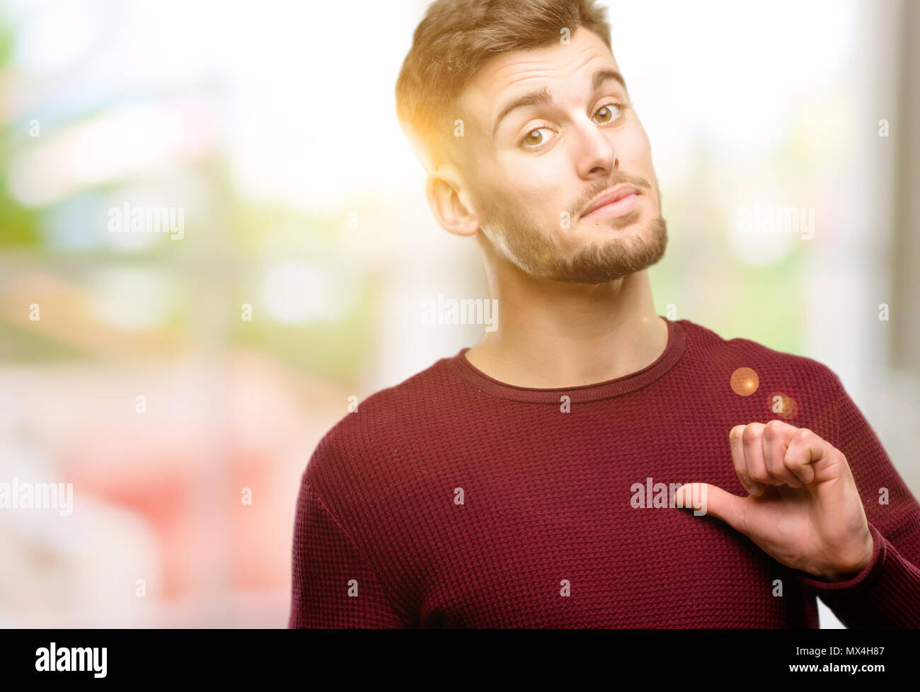 Handsome young man proud, excited and arrogant, pointing with victory face Stock Photo