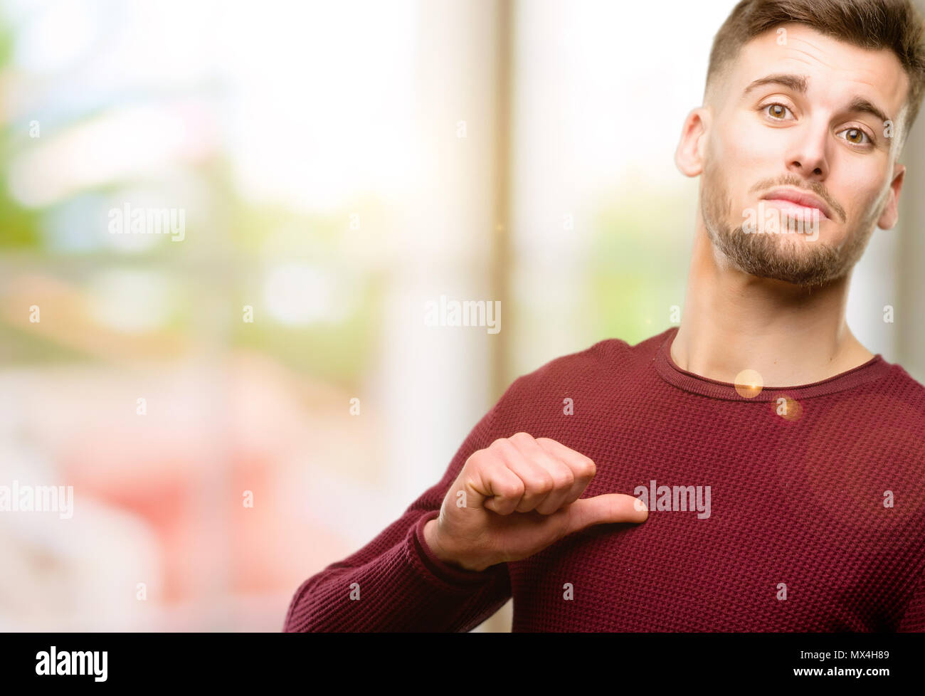 Handsome young man proud, excited and arrogant, pointing with victory face Stock Photo