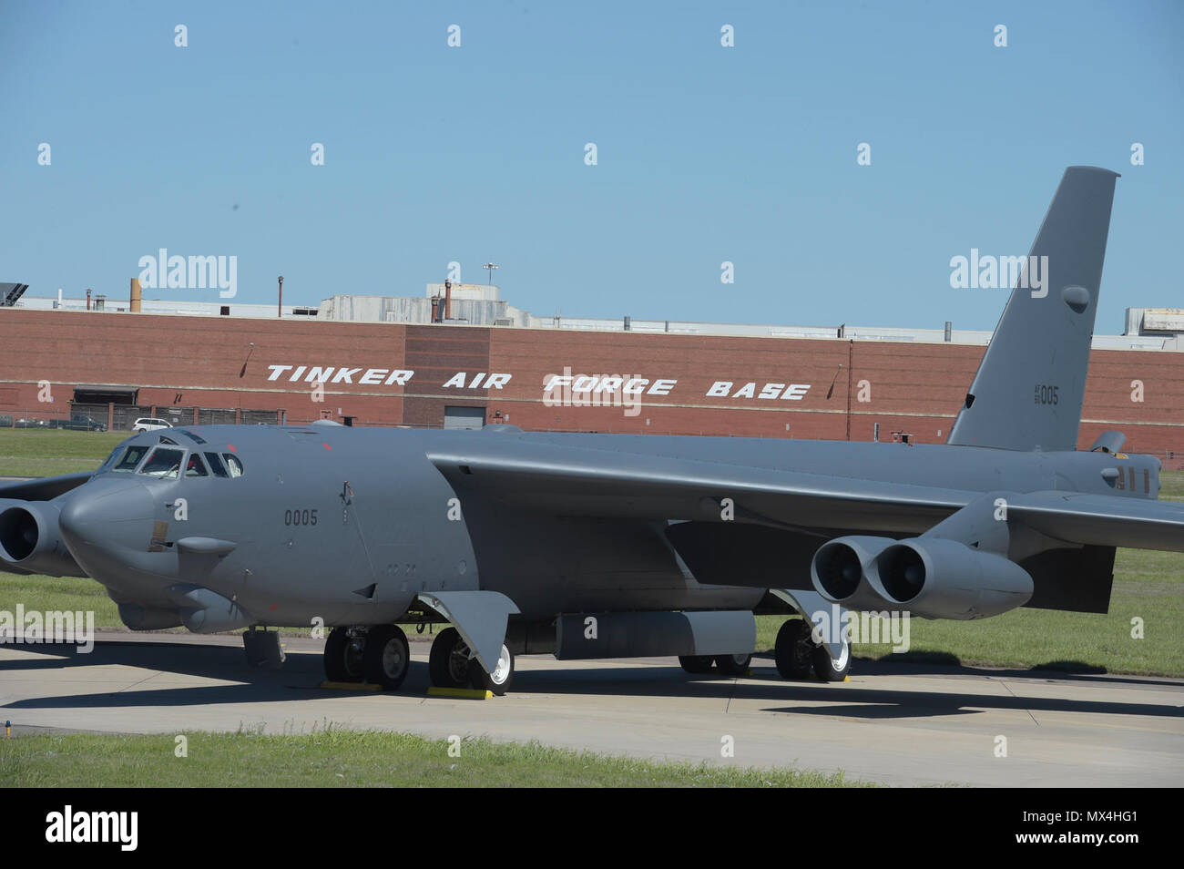 Boeing B-52H, 60-0005, poses in front of Oklahoma City Air Logistics Complex Bldg. 3001 following major overhaul on May 1, 2017, Tinker Air Force Base, Oklahoma. OC-ALC is responsible for depot level maintenance of the B-52 fleet with a large portion of the work taking place in the building shown behind. Stock Photo