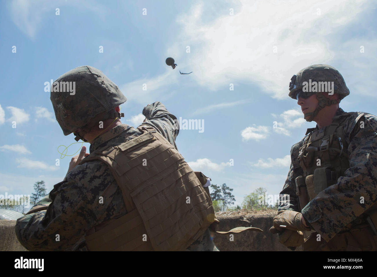 A Marine throws an M67 fragmentation grenade during a grenade range at