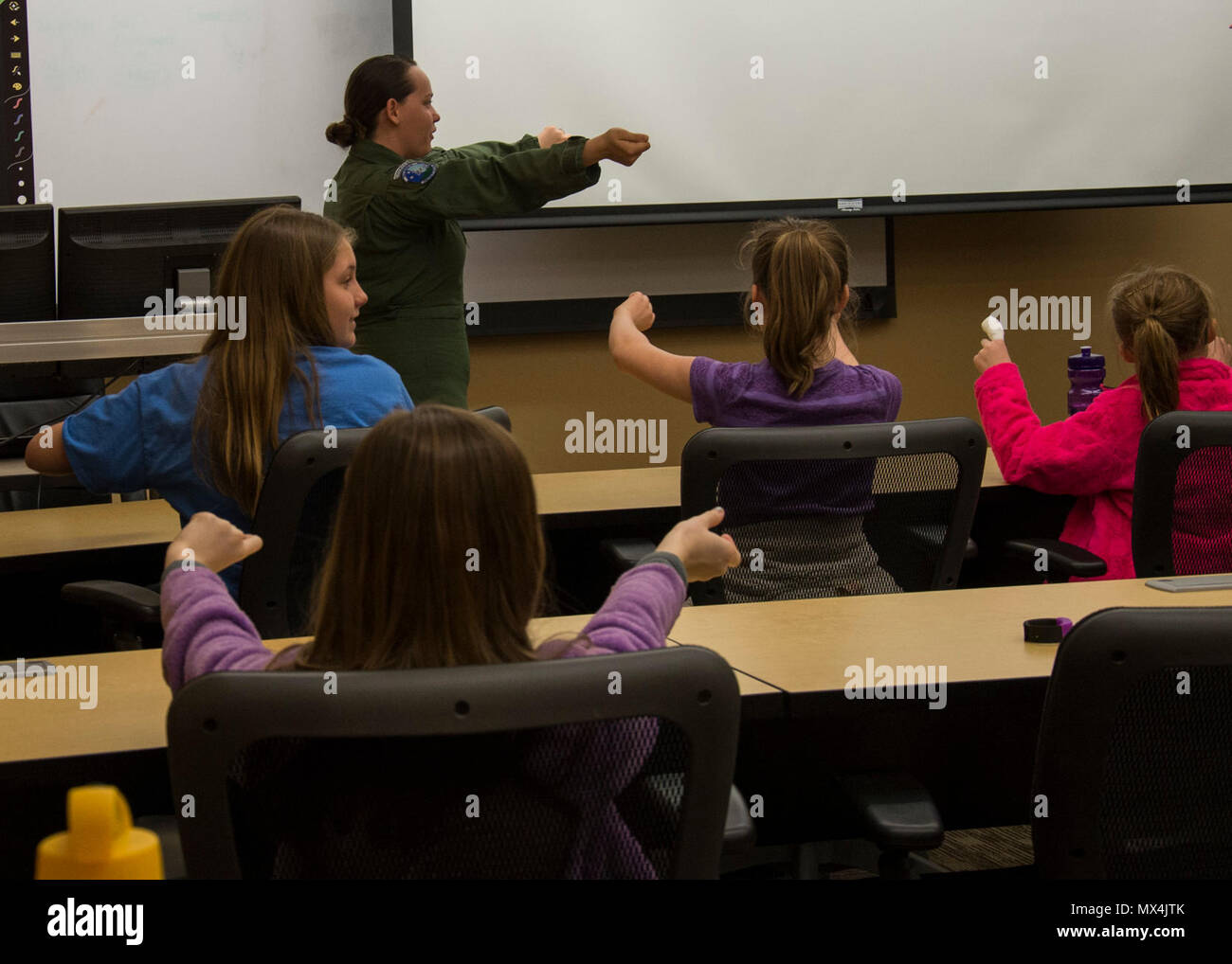 1st Lt. Katelyn Woodley, 741st Missile Squadron intercontinental ballistic missile combat crew commander, teaches Edison Elementary School’s science, technology, engineering and math girls to launch a missile at the Missile Procedures Trainer on Minot Air Force Base, N.D., May 1, 2017. The STEM girls learned the basics of a missileer’s job, including the necessary procedures of a missile launch. Stock Photo