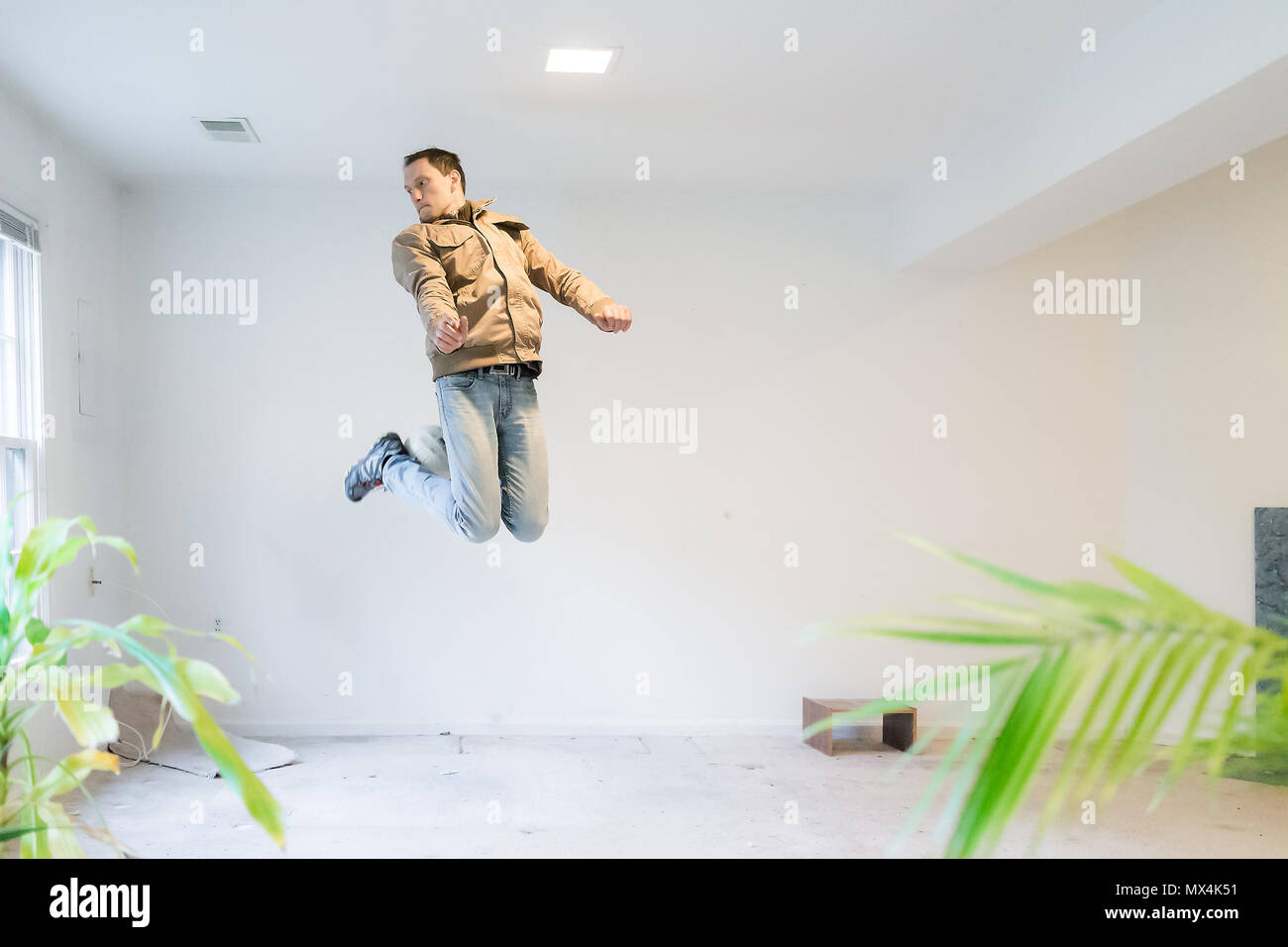 Skilled Young Man Jumping Up Performing Mid Air Trick With Soccer