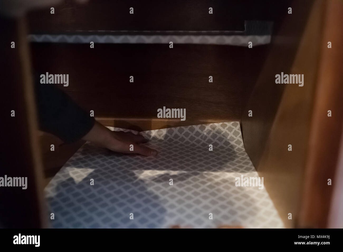 Man Placing Protective Adhesive Liner Sheet Inside On Wooden