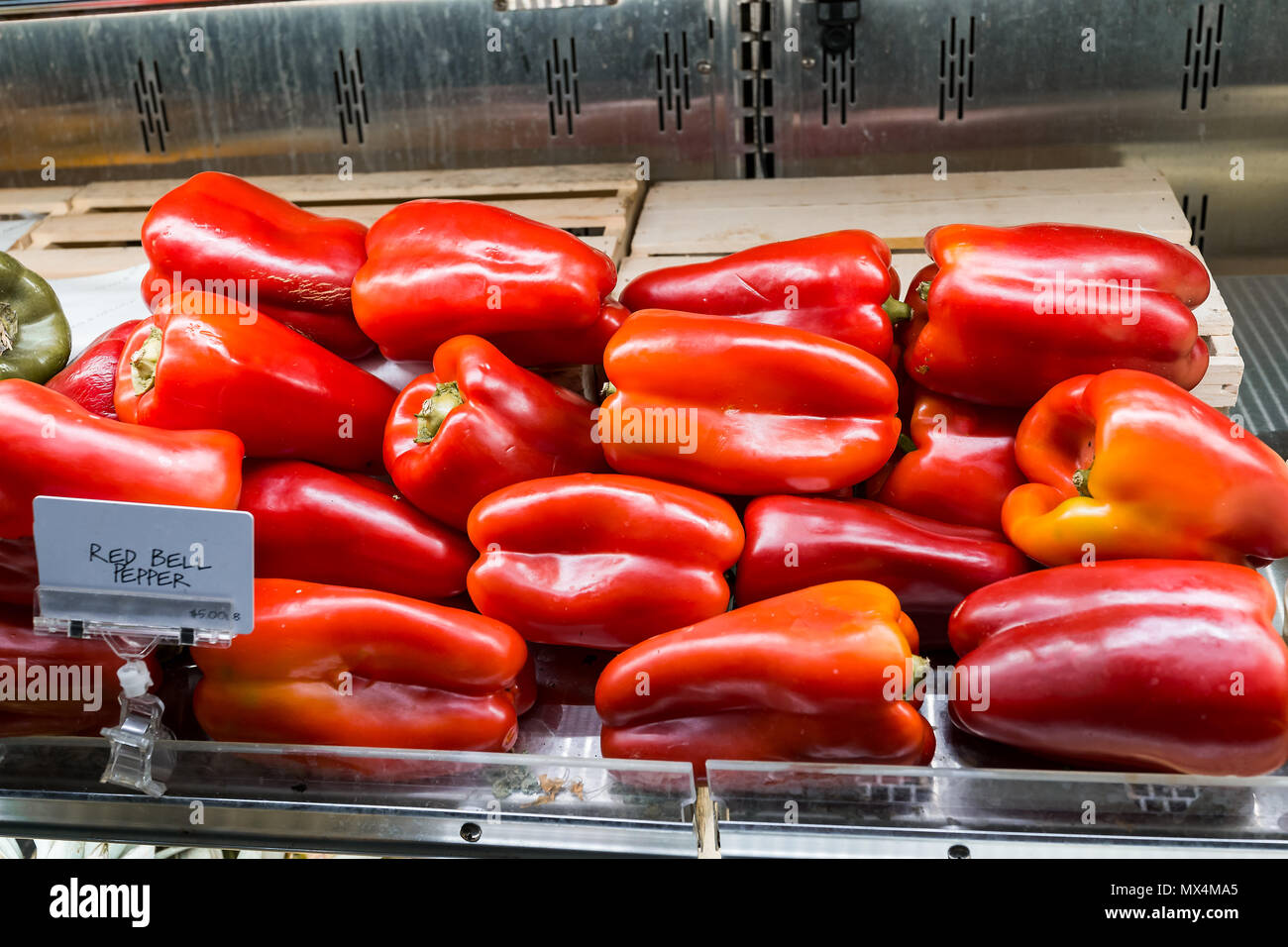 Closeup of fresh raw, expensive large whole red bell pepper in supermarket grocery market store