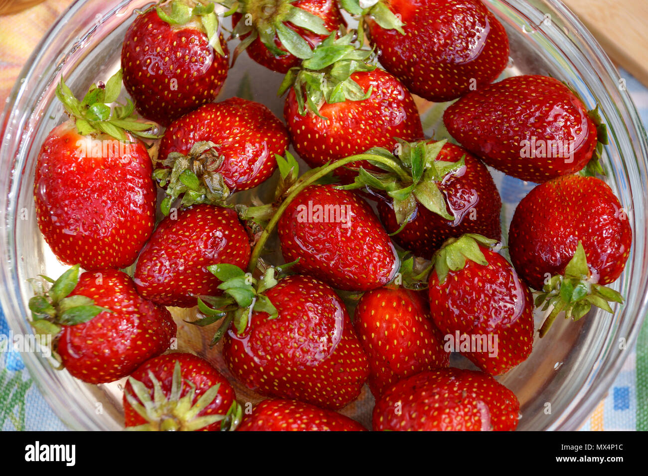 Fresh strawberry in capacity with water Stock Photo