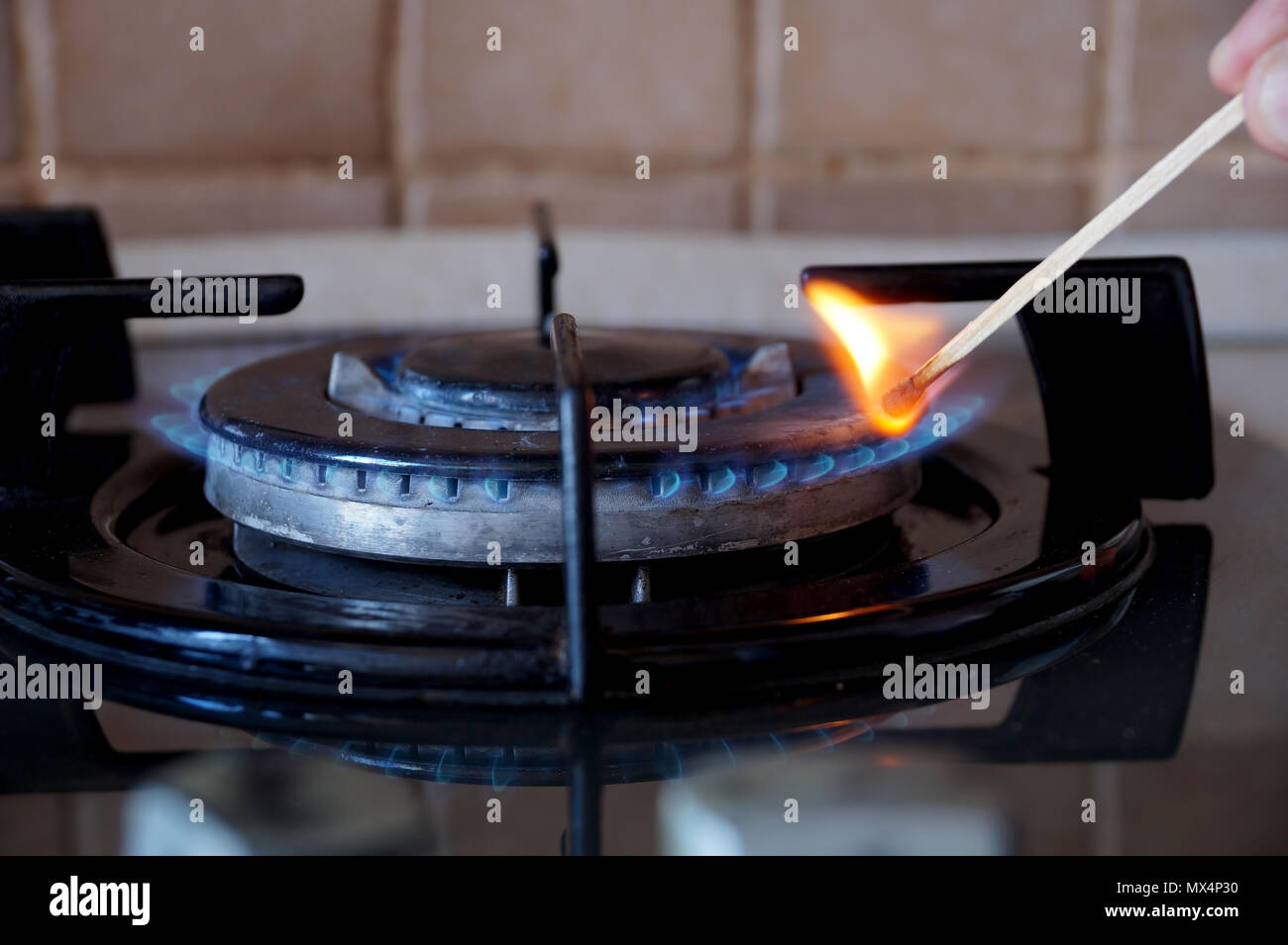 Ignition of a gas ring on the stove Stock Photo