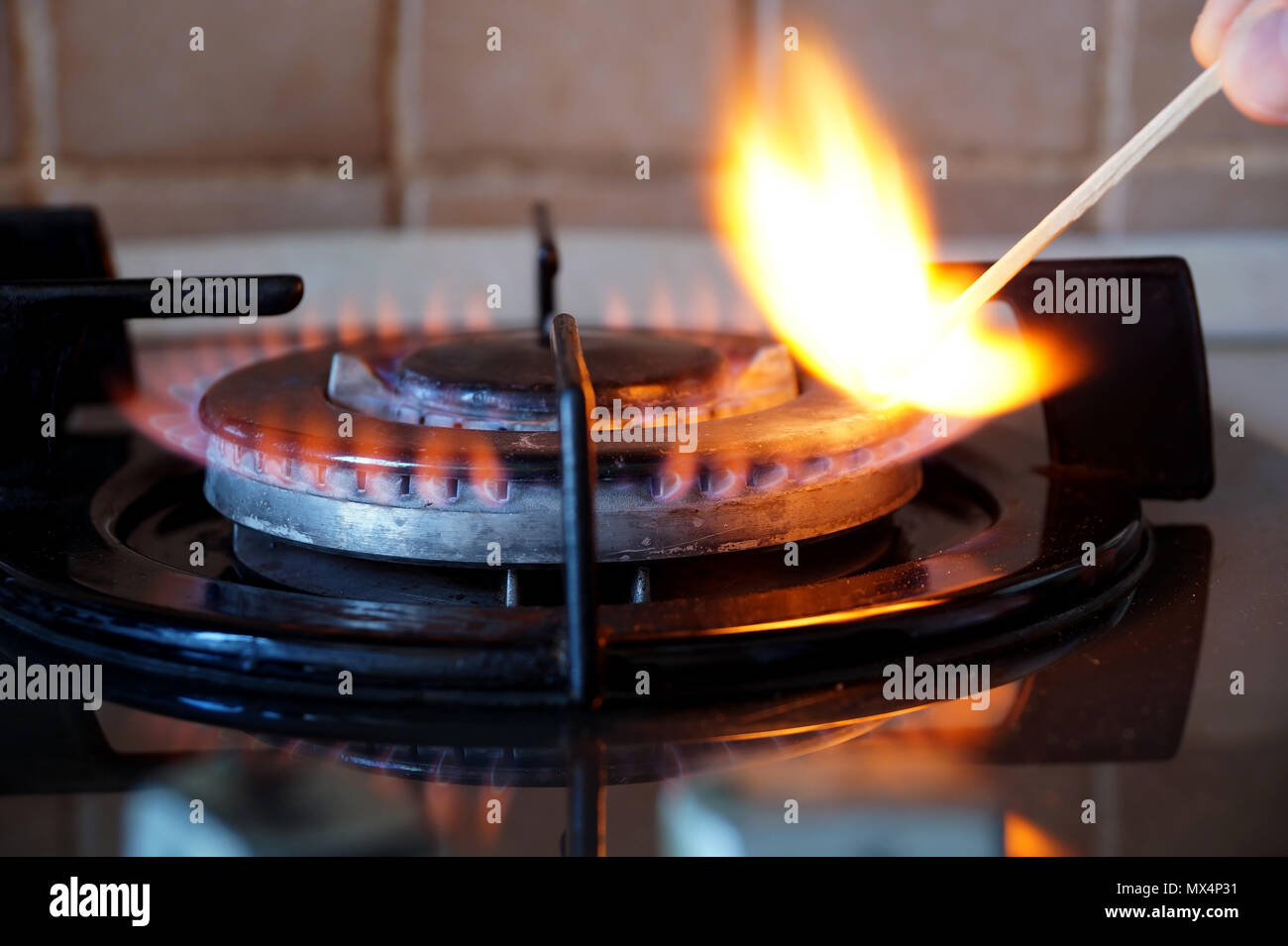 Ignition of a gas ring on the stove Stock Photo