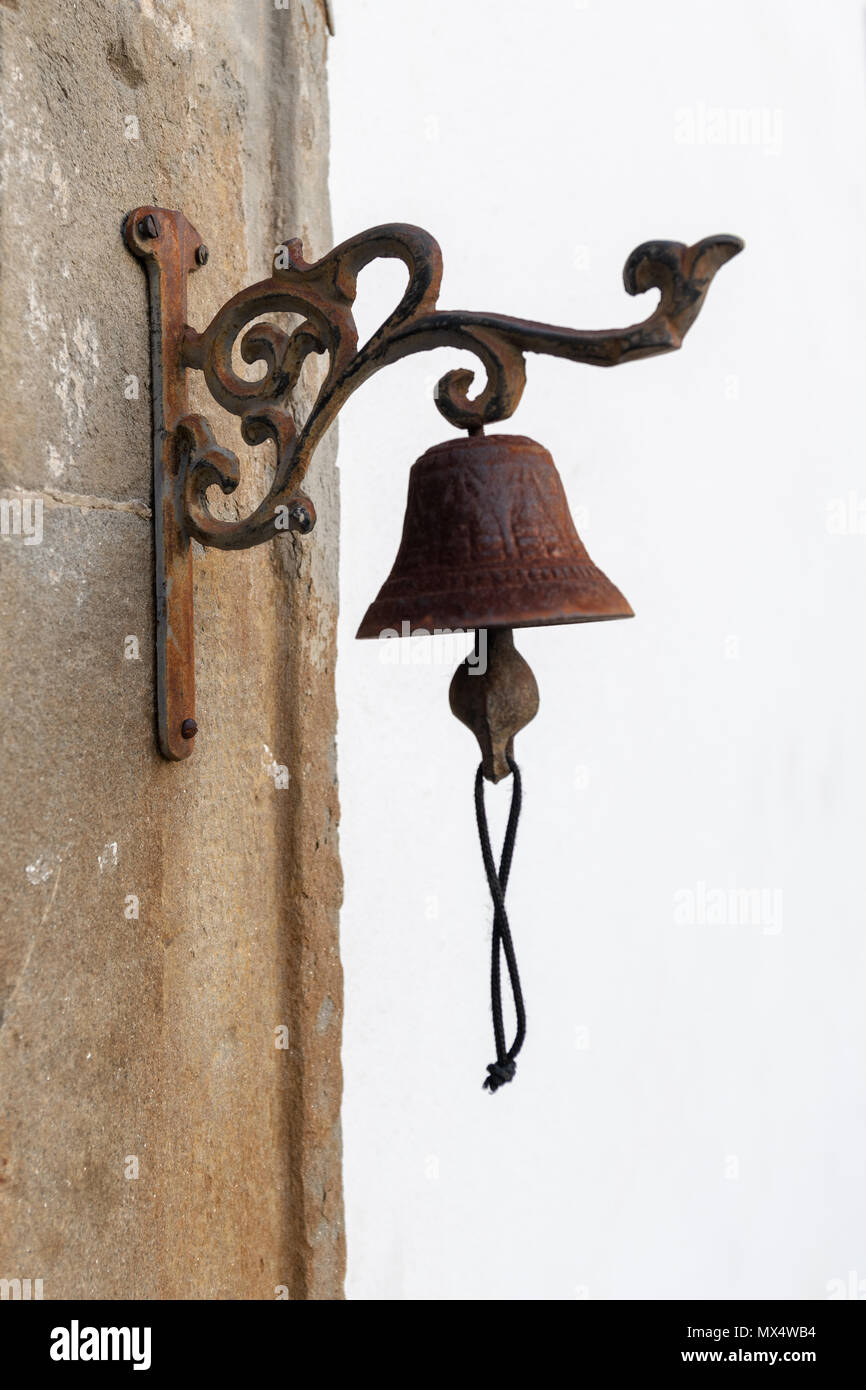 Antique brass bell on the back of the door and early doorbell Stock Photo -  Alamy