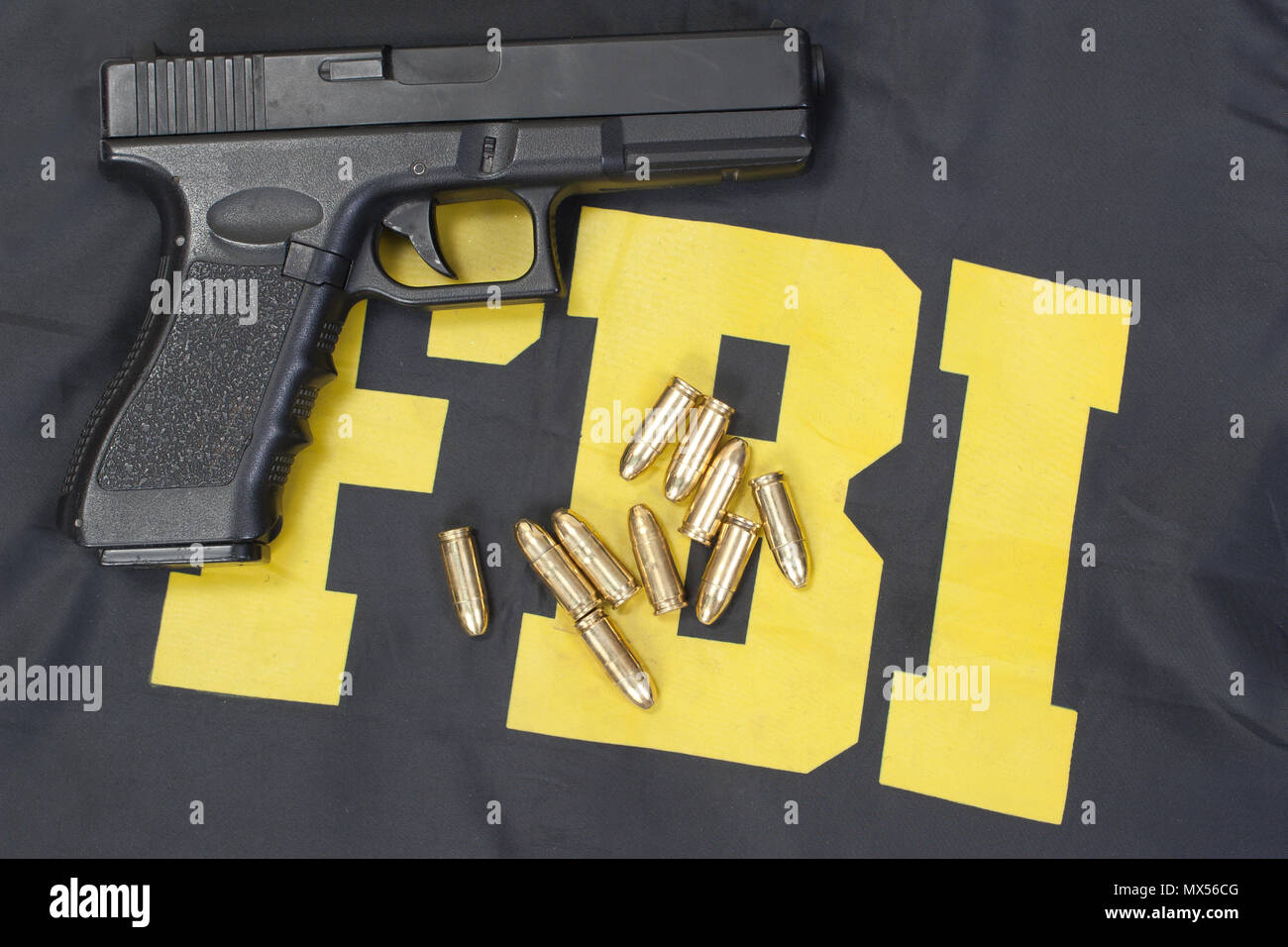 9mm handgun with ammo on fbi uniform Stock Photo