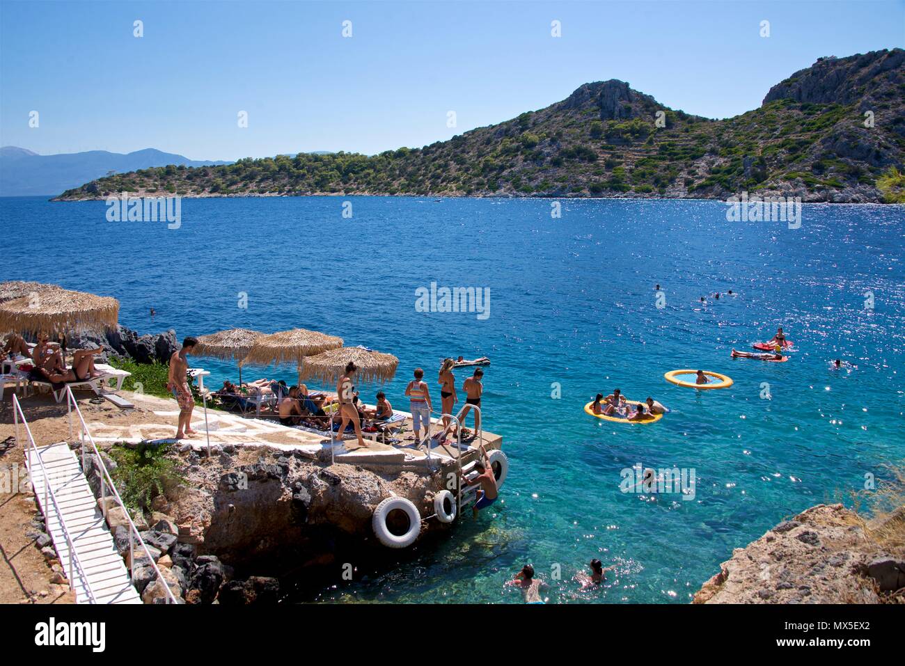 Swimmers in blue waters of Akgistri, Greece Stock Photo
