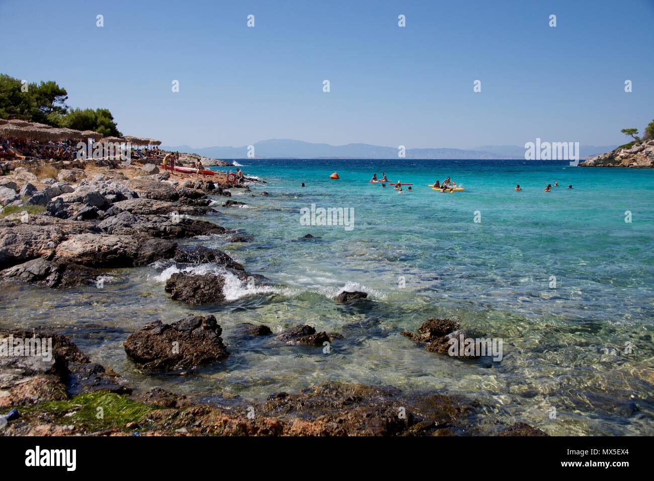 Swimmers in blue waters of Akgistri, Greece Stock Photo