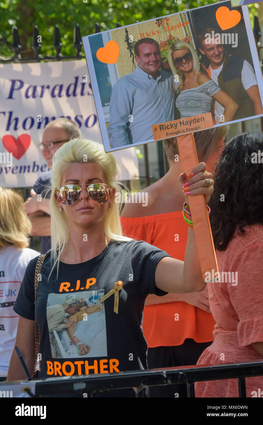 London, UK. 3rd June 2018. A woman wearing a t-shirt with the message 'R.I.P. Brother holds a placard for Ricky Hayden' as community groups and campaigners against knife and gun crime protest opposite Downing St, calling on Theresa May to take action to stop the growing number of killings using knives across the country. The event was organised by Anti-Knife UK, founded by Danny O'Brien in 2008 which monitors knife crime incidents from across the UK on a daily basis. Credit: Peter Marshall/Alamy Live News Stock Photo