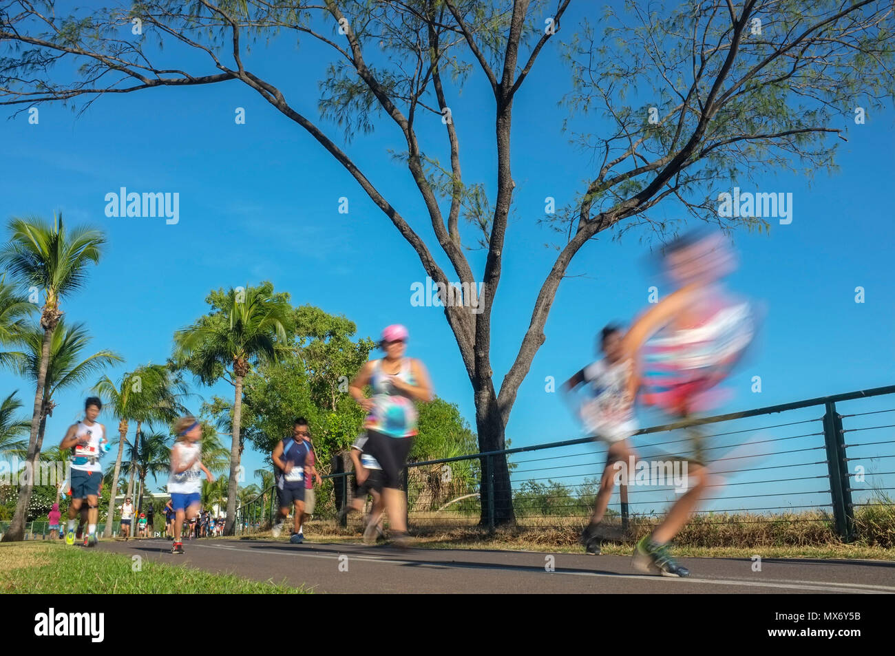 People taking part in the 12 km fun run City 2 Surf on the Nightcliff foreshore in Darwin, Northern Territory, Australia. With motion blur. Stock Photo