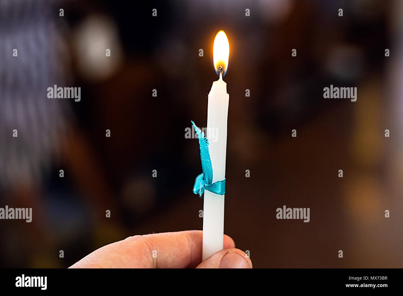 Lighted candle during a baptism ceremony Stock Photo Alamy