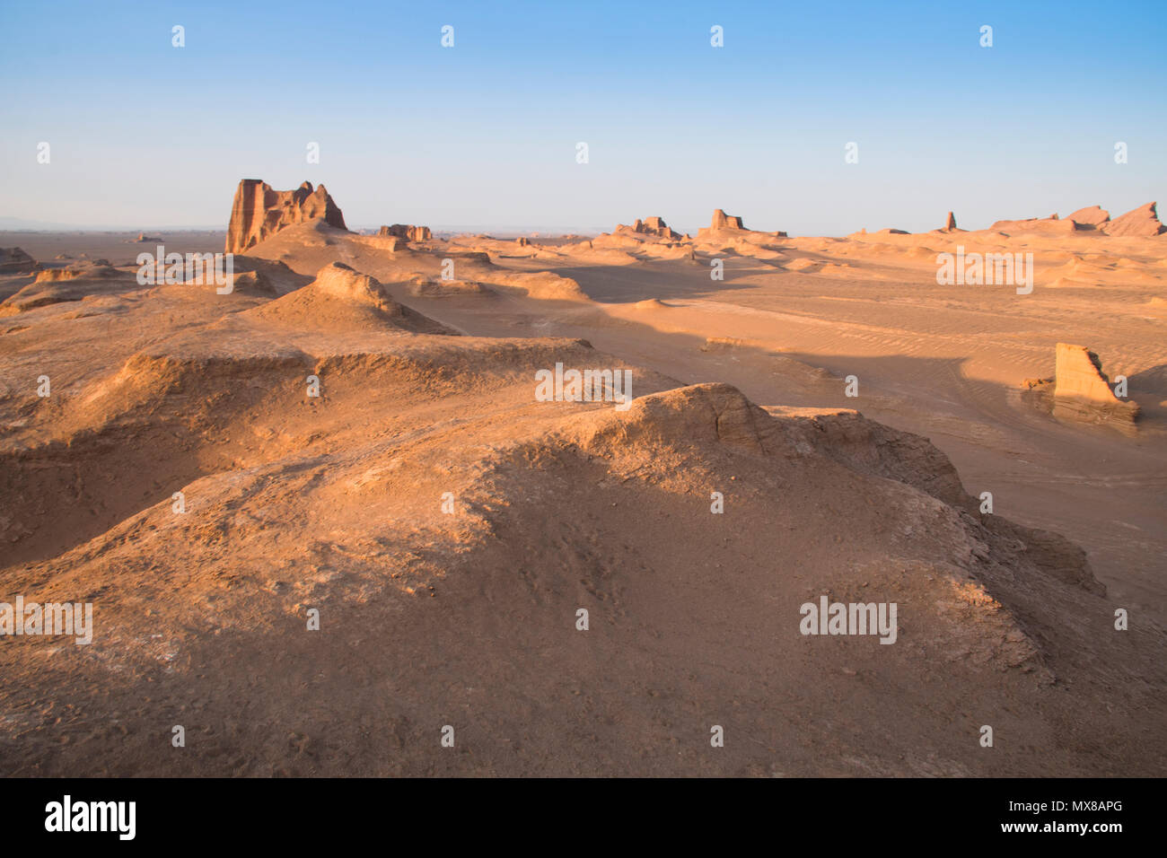 Sunset at the magnificent Dasht-e Lut deserts, famous for its rock formations called Kaluts or Kalouts near the city Kerman in Iran Stock Photo