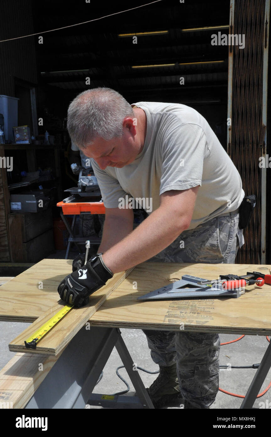 Master Sgt. Tommy Miller, 919th Special Operations Civil Engineering Squadron water fuel system specialist, measures a backing board to be used on a building May 2, 2017 for the 53rd Weather Reconnaissance Squadron, Detachment 1 located at Henry E. Rohlsen Airport in St. Croix, U.S. Virgin Islands. The repairs and improvements were completed by Members of the 919th Special Operations Civil Engineering Squadron during the annual 'roll-out' for the upcoming hurricane season, April 30-May 10. Stock Photo