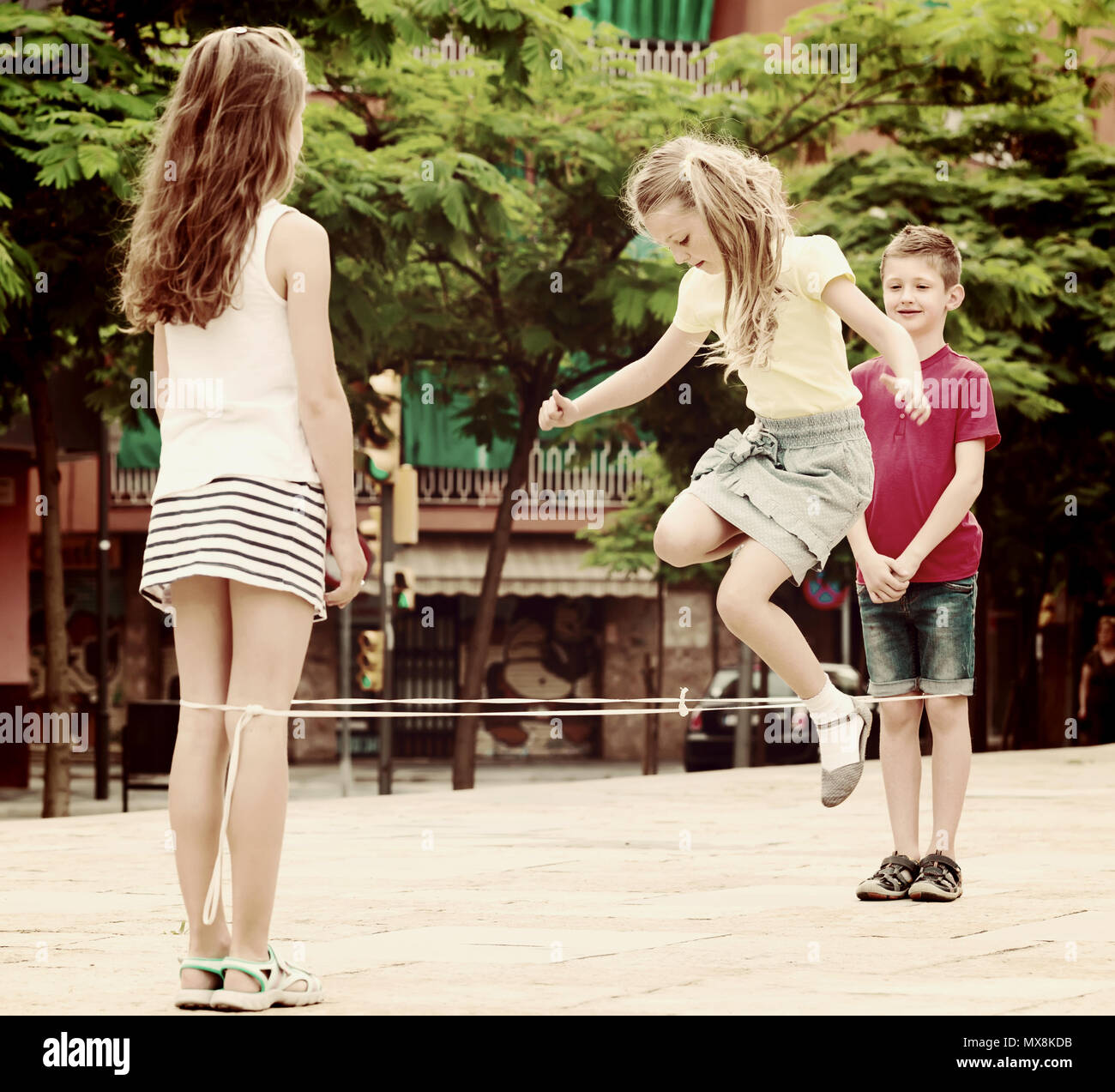 happy boy and girls in elementary school age playing with chinese ...