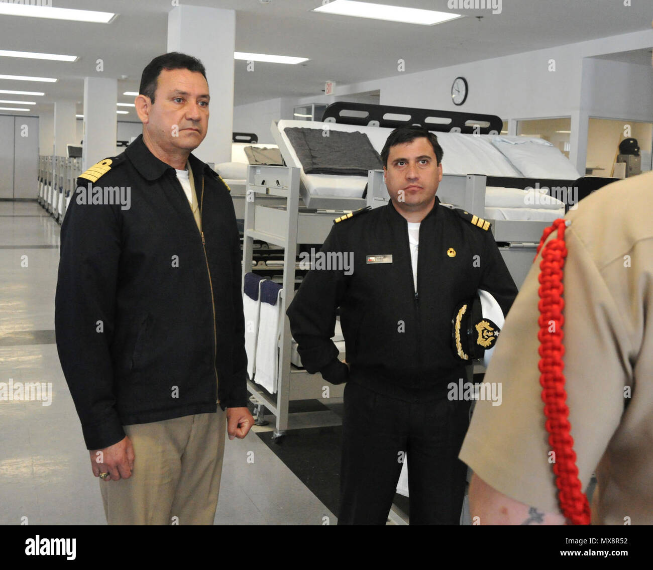 GREAT LAKES, Il. (May 03, 2017) Capt. Xavier Flament, Mexican Navy, and Cmdr. Jorge Toso, Chilean Navy listen to a Recruit Division Commander give a brief on recruit barracks living during a foreign officers tour May 3, at Recruit Training Command. The visit included four senior foreign liaison members from U.S. Fleet Forces Command who toured RTC and Training Support Center over a three-day period. The officers were representing the Mexican, Brazilian, Chilean, and Peruvian navies.  About 30,000-40,000 recruits graduate annually from the Navy's only boot camp. Stock Photo