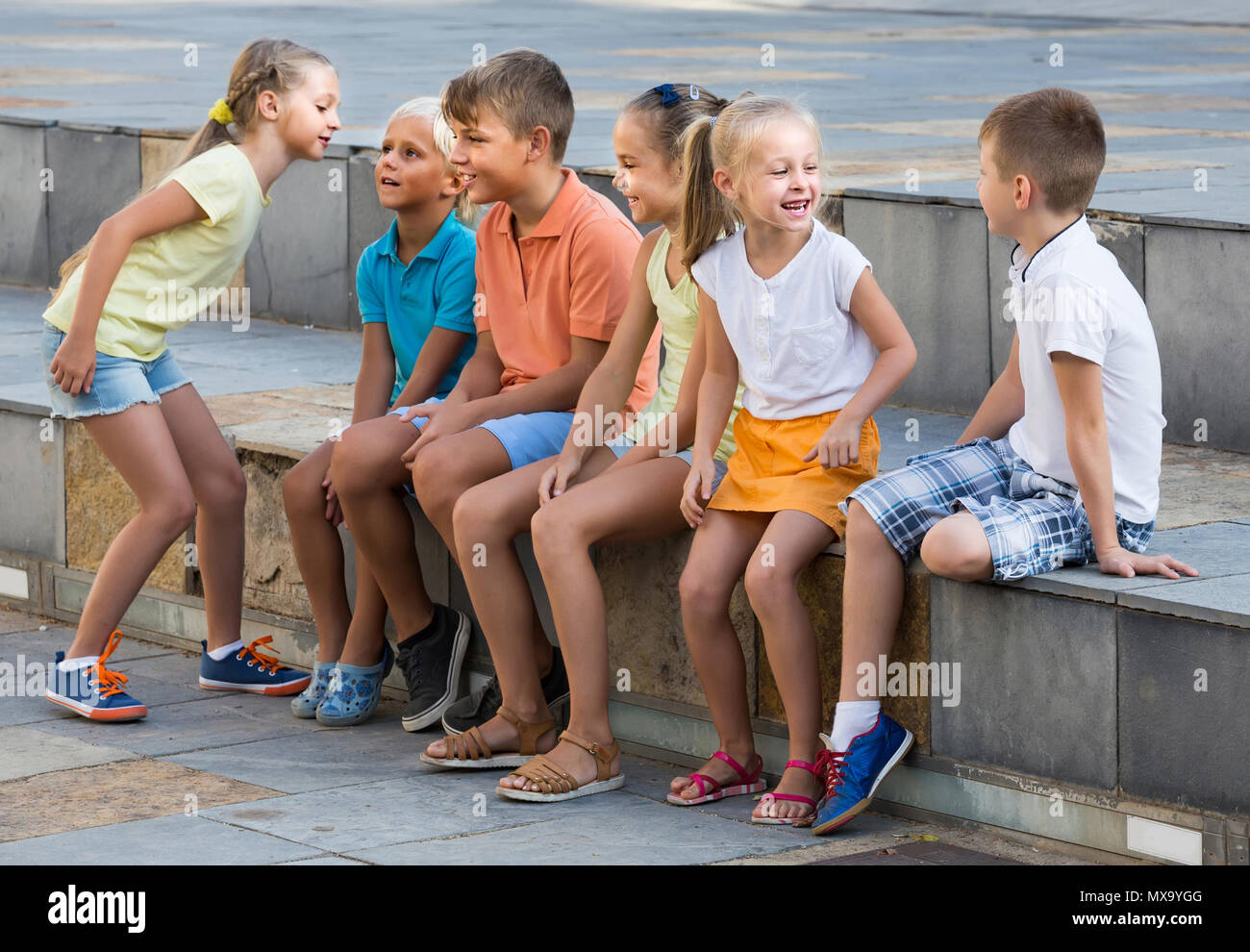 portrait of happy spanish children spending time outside and playing ...