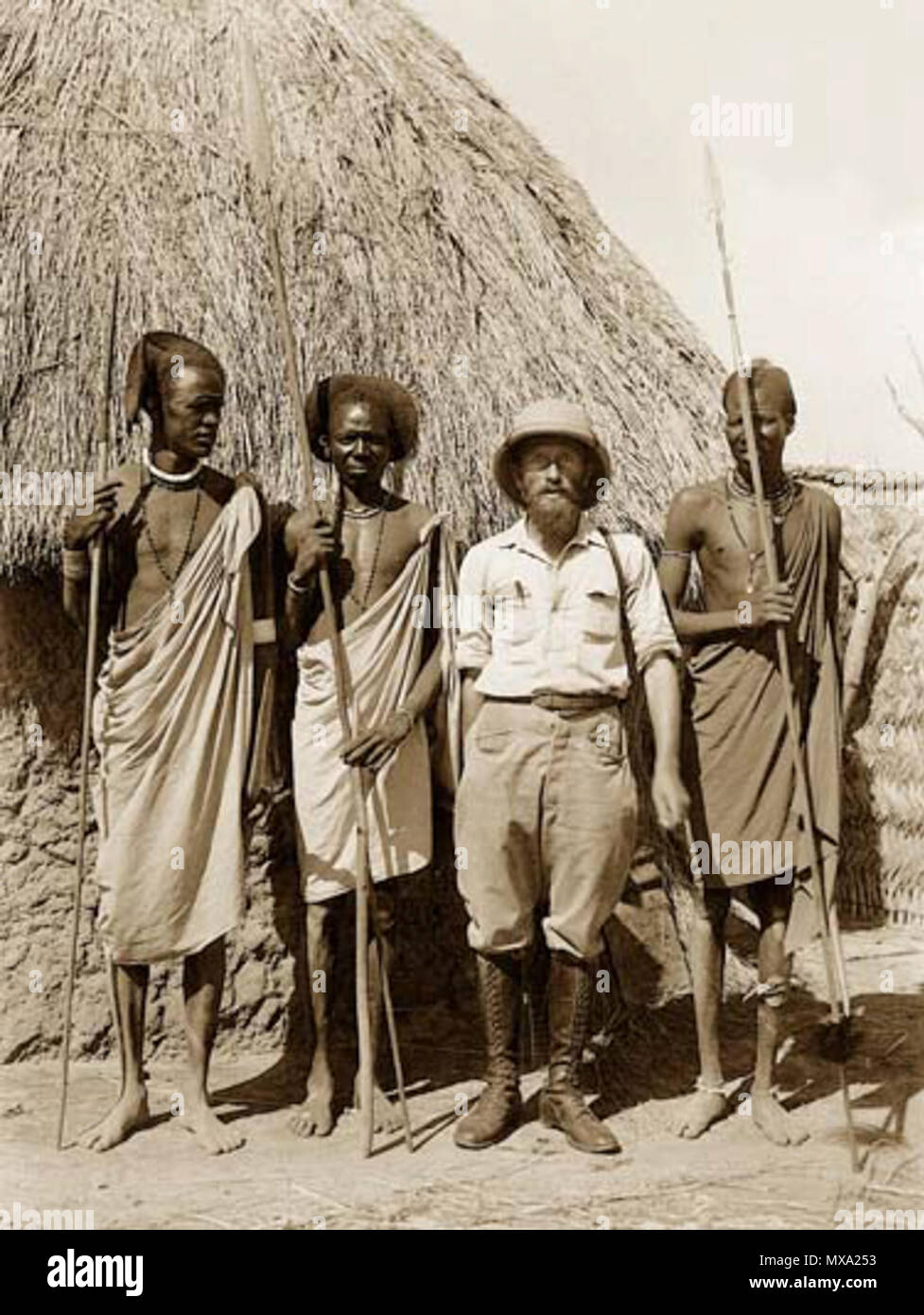 . Kazimierz Nowak among African wariors. The photo probably taken by Kazimierz Nowak (1897-1937, the author is on the photo; taken probably by a self-timer) during his trip through Africa - a Polish traveller, correspondent and photographer. Probably the first man in the world who crossed Africa alone from the North to the South and from the South to the North (from 1931 to 1936; on foot, by bicycle and canoe). circa about 1931-36. probably Kazimierz Nowak or an unknown author 42 Among African wariors Stock Photo