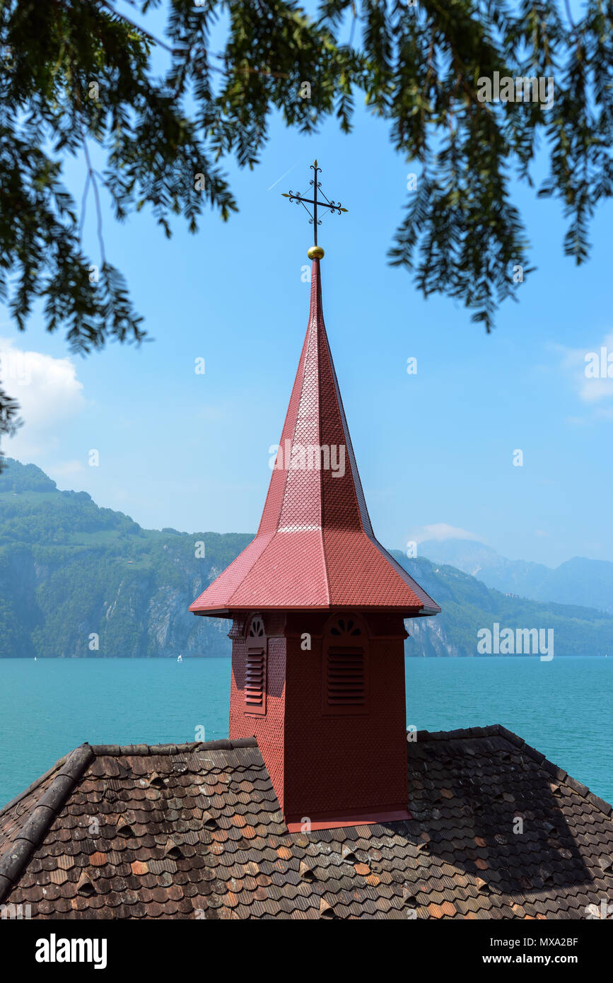 Top of Tells chapel roof spire cross over Lake Lucerne turquoise waters on Tellsplatte, Sisicon, Canton of Uri, Switzerland on summer spring clear day Stock Photo