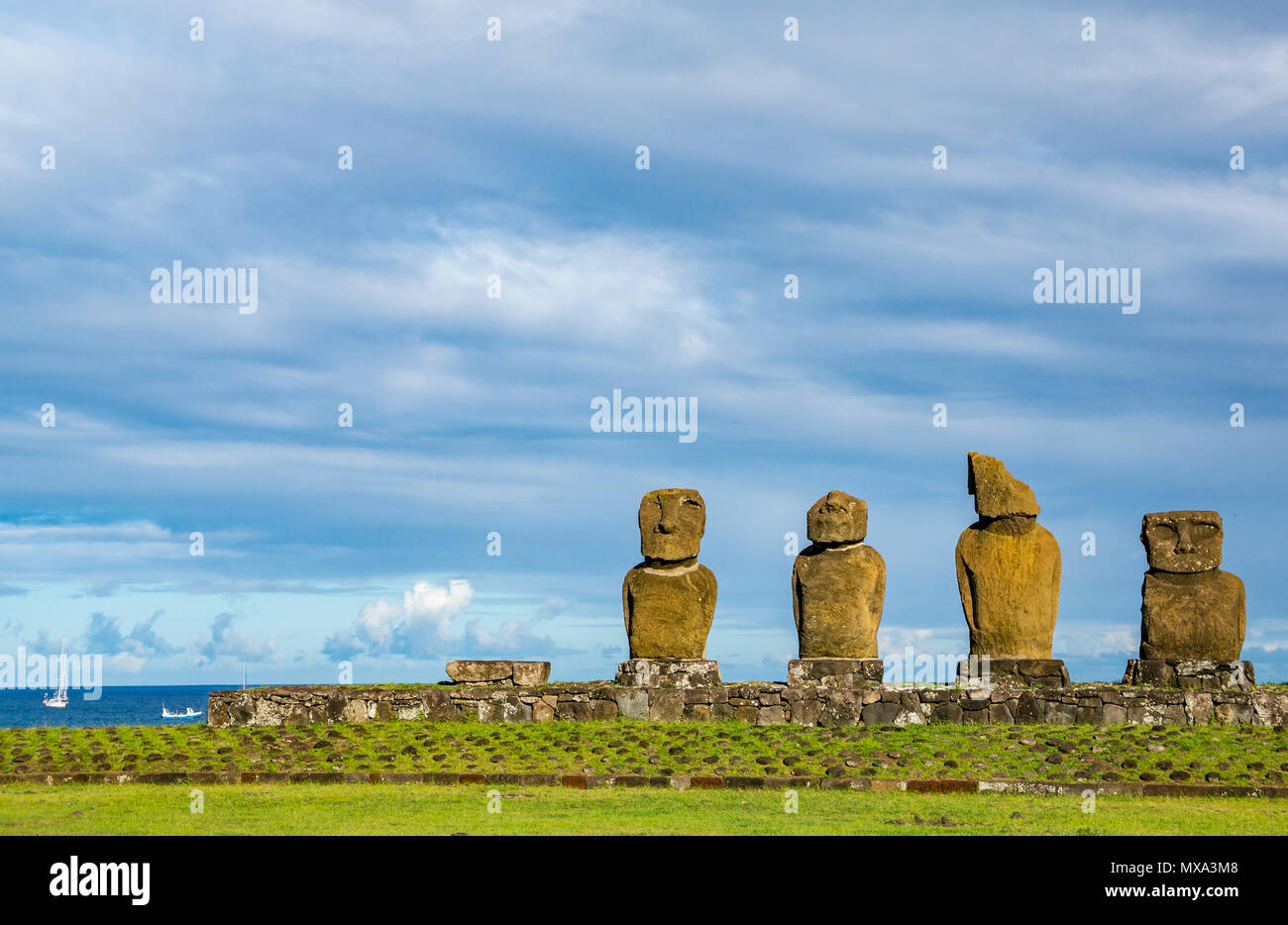 Ahu Vai Ure Moai, Tahai, Hanga Roa, Easter Island, Rapa Nui, Chile, with sailing boats in the Pacific Ocean Stock Photo