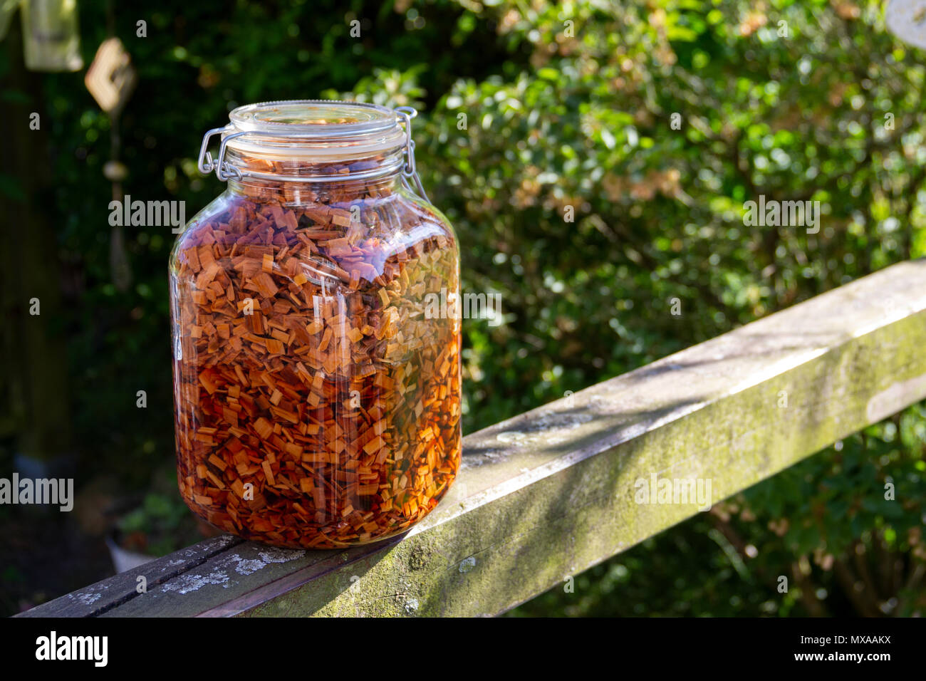 Wood chips is a bottle. Wooden Chips for bbq smoke flavor. Stock Photo