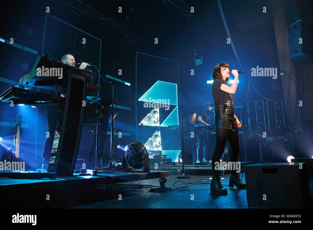 CHVRCHES performing live onstage during the Every Open Eye tour. Pictured are lead singer Lauren Mayberry (front), Iain Cook (back, close) and Martin Doherty (back, far). CHVRCHES band, CHVRCHES live, CHVRCHES in concert, Churches band. Stock Photo